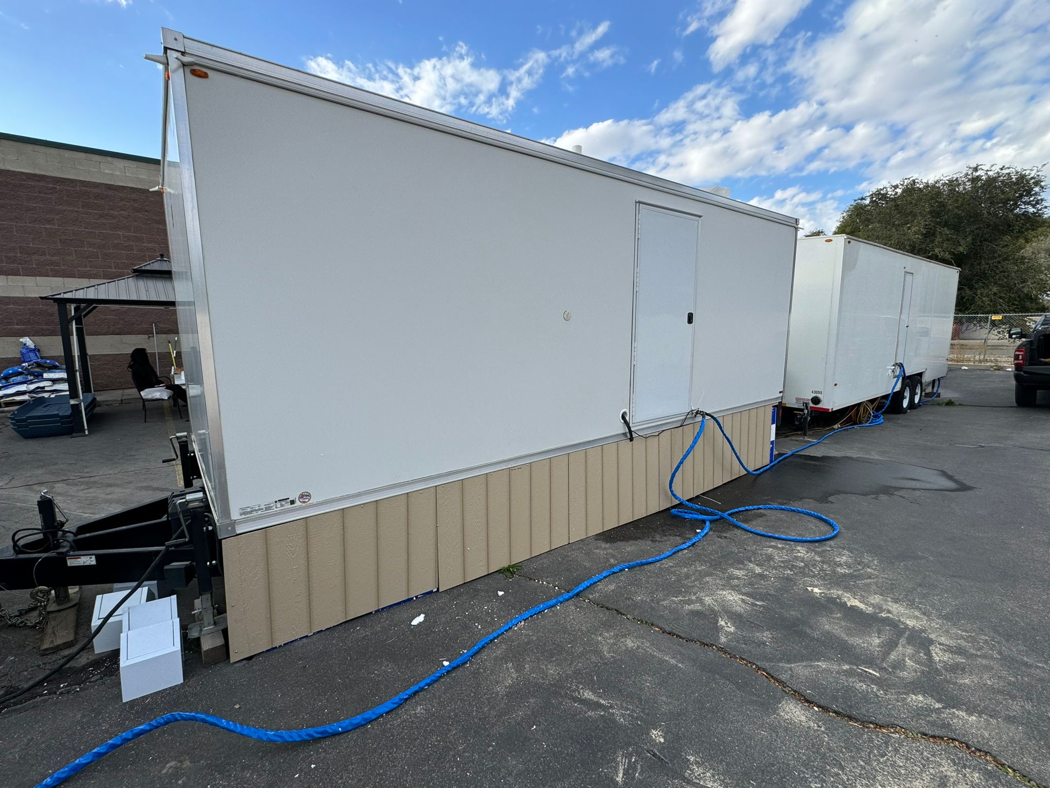 KryoFridge refrigerated trailer backed to a loading dock with its power line connected