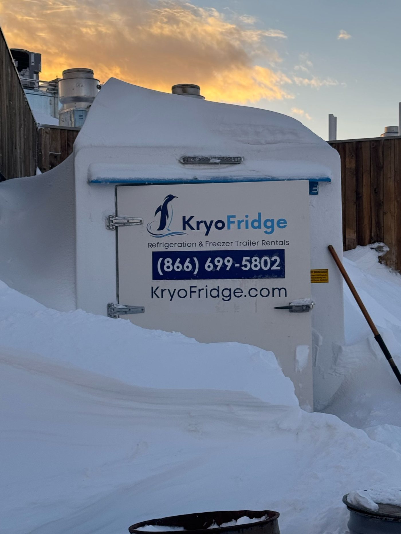 Close view of a branded KryoFridge freezer trailer with the 866-699-5802 phone number, staged for a quick-serve restaurant