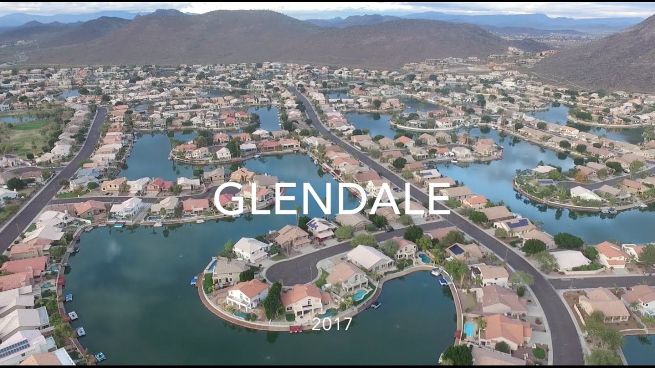 Aerial view of Glendale, Arizona, across the West Valley toward the desert mountains, with Loop 101 cutting through the city