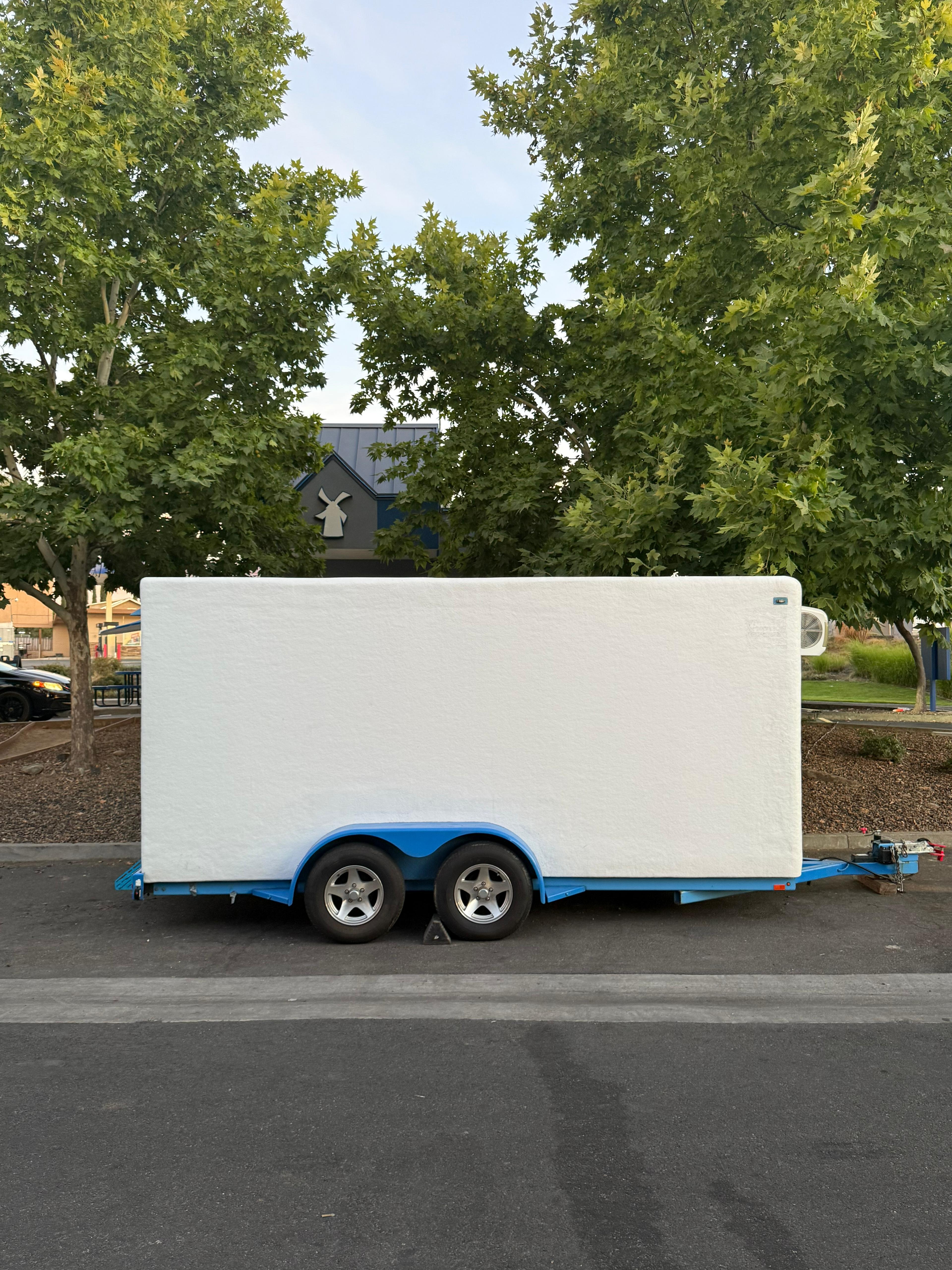 KryoFridge white-and-blue freezer trailer in side profile, staged for a Glendale, Arizona cold-storage delivery