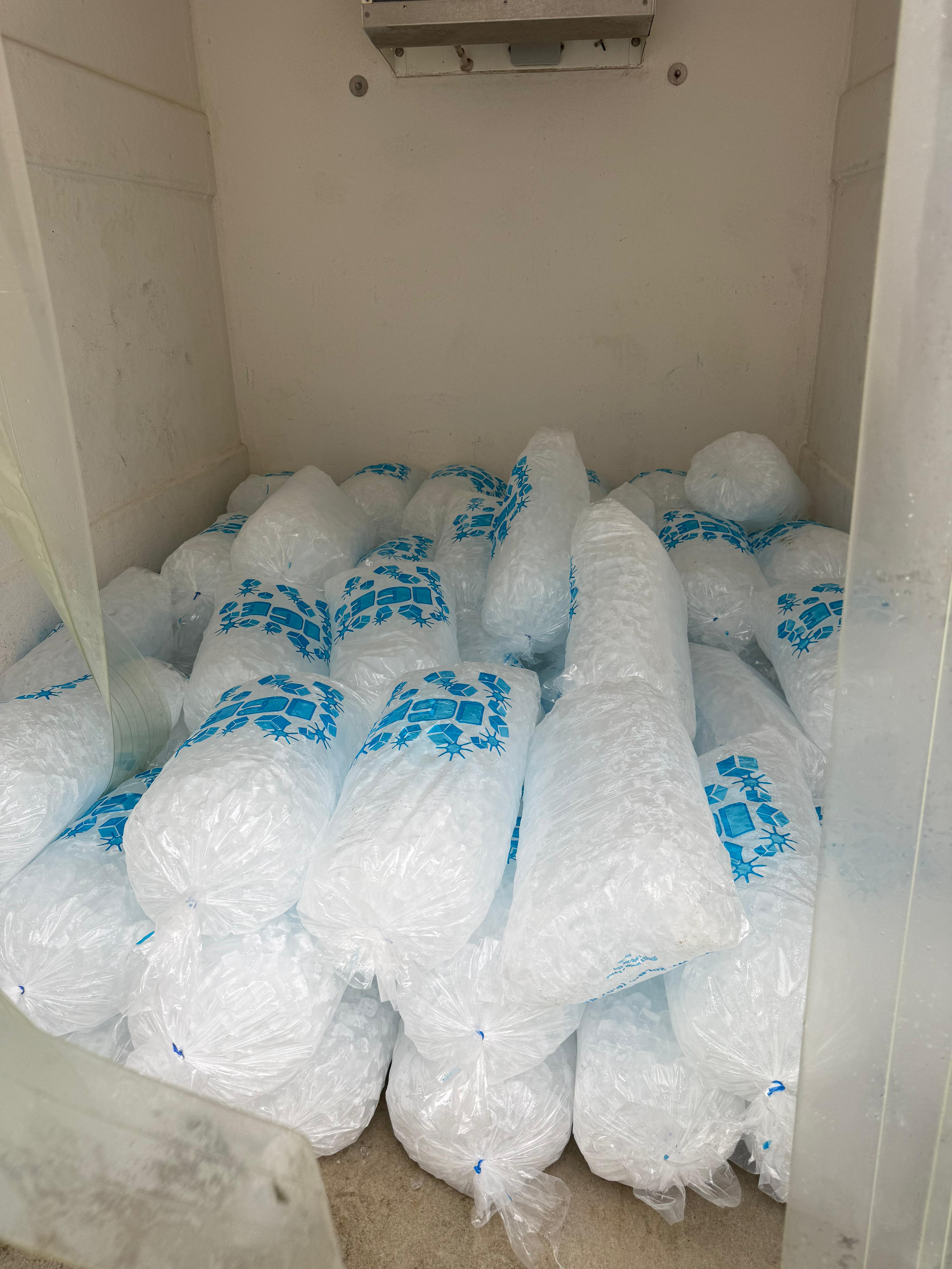 Interior of a KryoFridge freezer trailer loaded with bagged ice, food-safe insulated walls