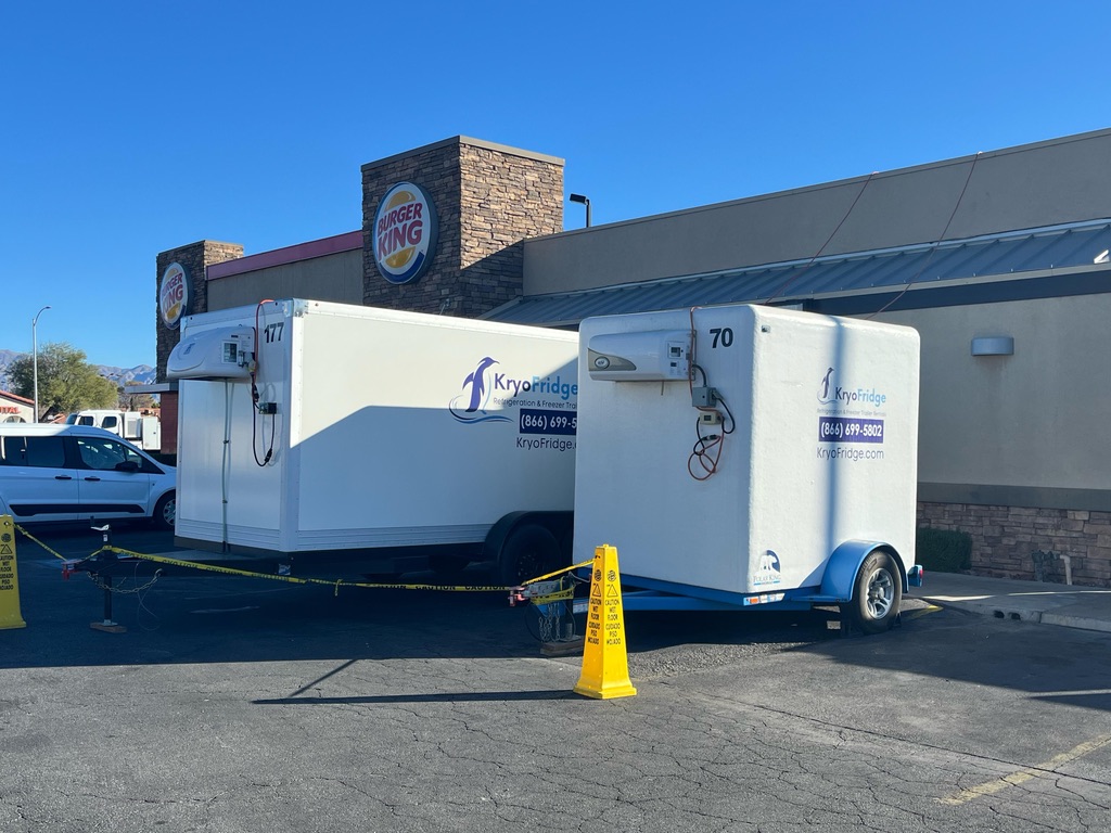 KryoFridge truck towing a branded freezer trailer, owner operated equipment dispatched directly instead of through a broker