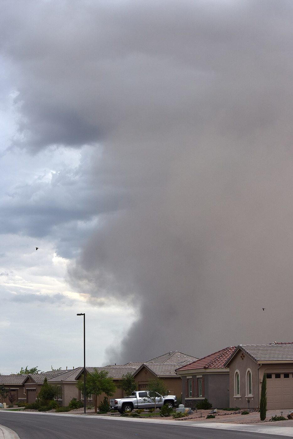 Haboob dust storm rolling over an East Valley neighborhood near Mesa, the kind of monsoon event that strains the power grid