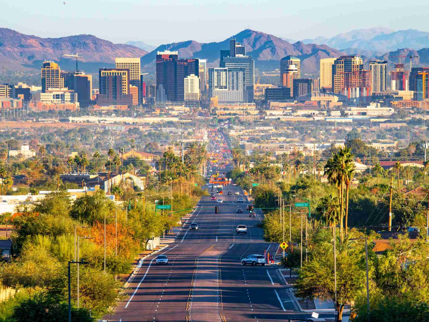 Phoenix skyline shimmering in summer heat with the McDowell Mountains beyond, where extreme temperatures strain every cooler in the city