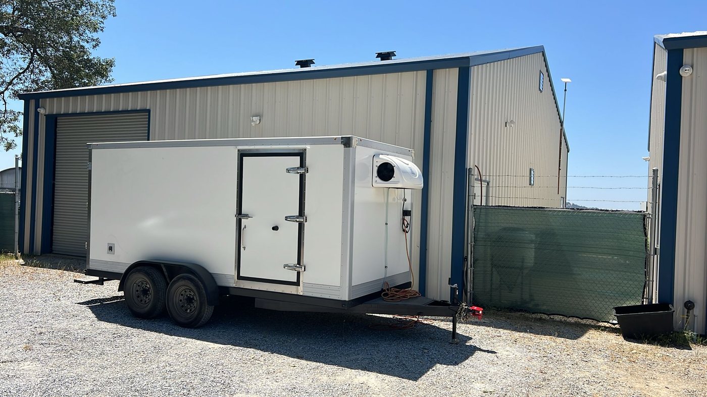 KryoFridge freezer trailer staged at a Phoenix warehouse loading dock