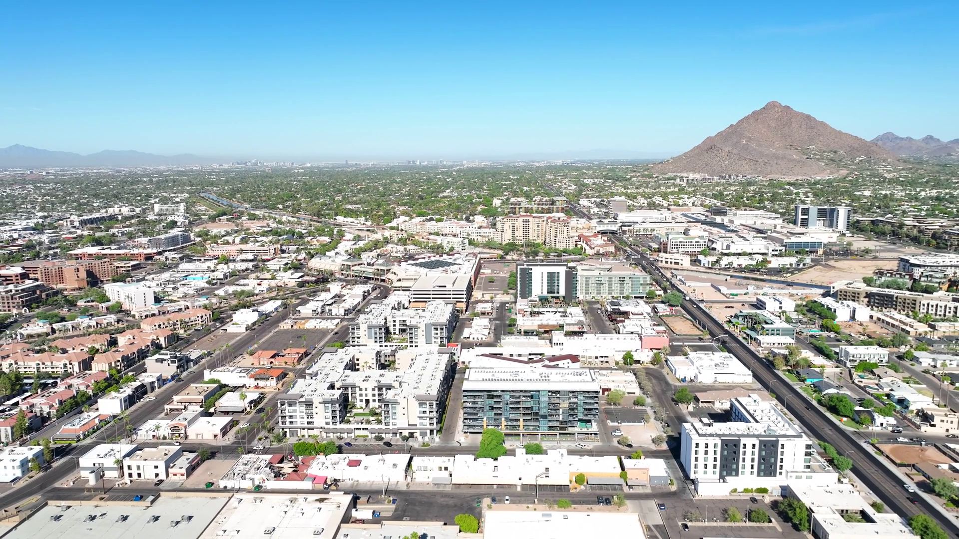 Aerial view of Scottsdale, Arizona, with desert resort districts spread toward Camelback Mountain and the McDowell range