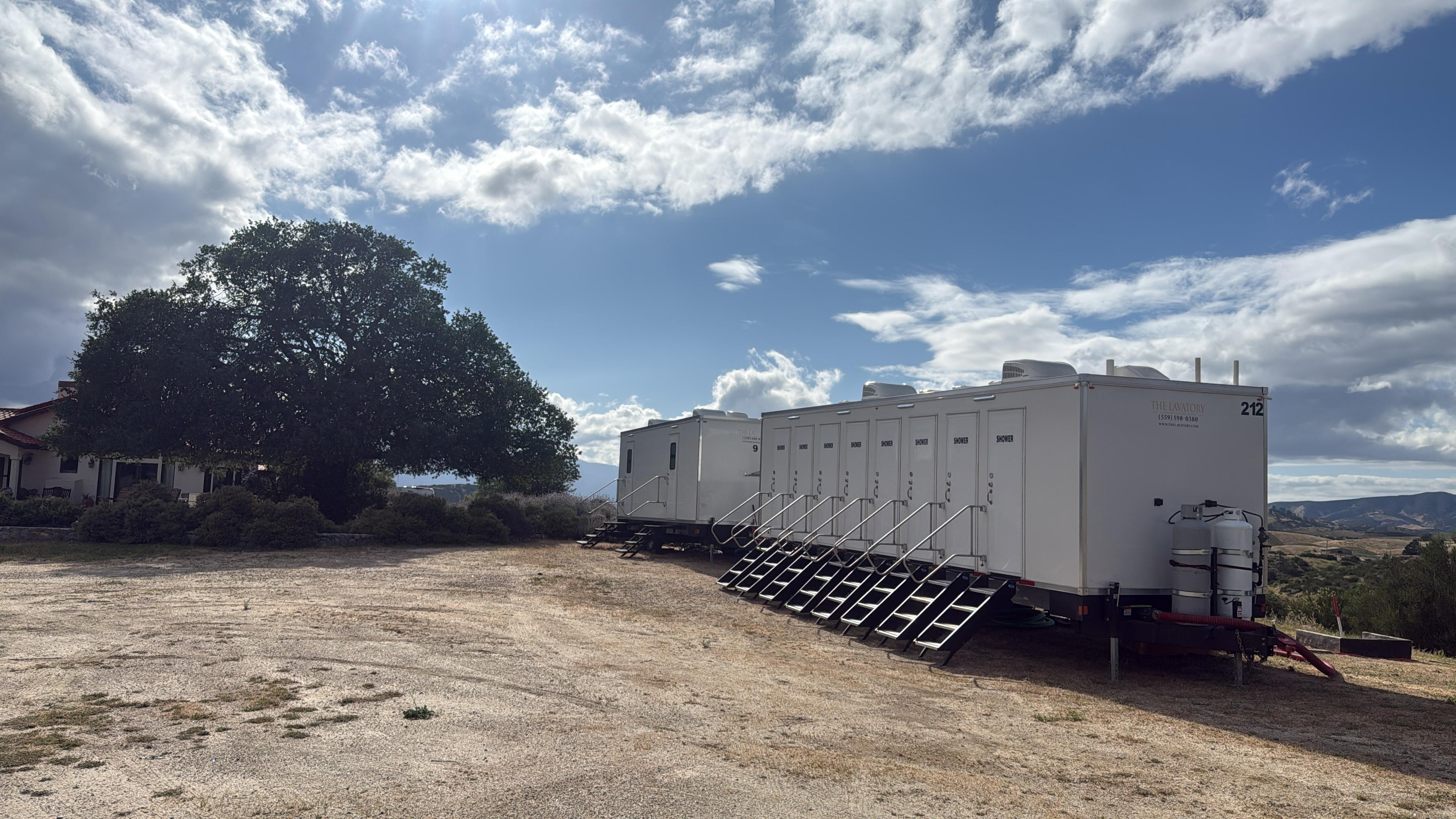 Clean white-and-blue KryoFridge freezer trailer photographed against a desert mountain skyline