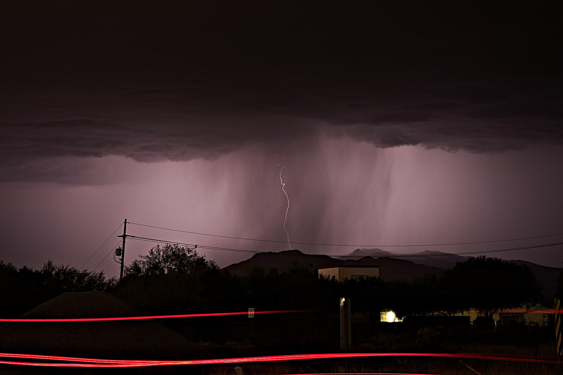 A summer monsoon storm rolling over the desert near Tucson at dusk, the kind of weather event that triggers power outages
