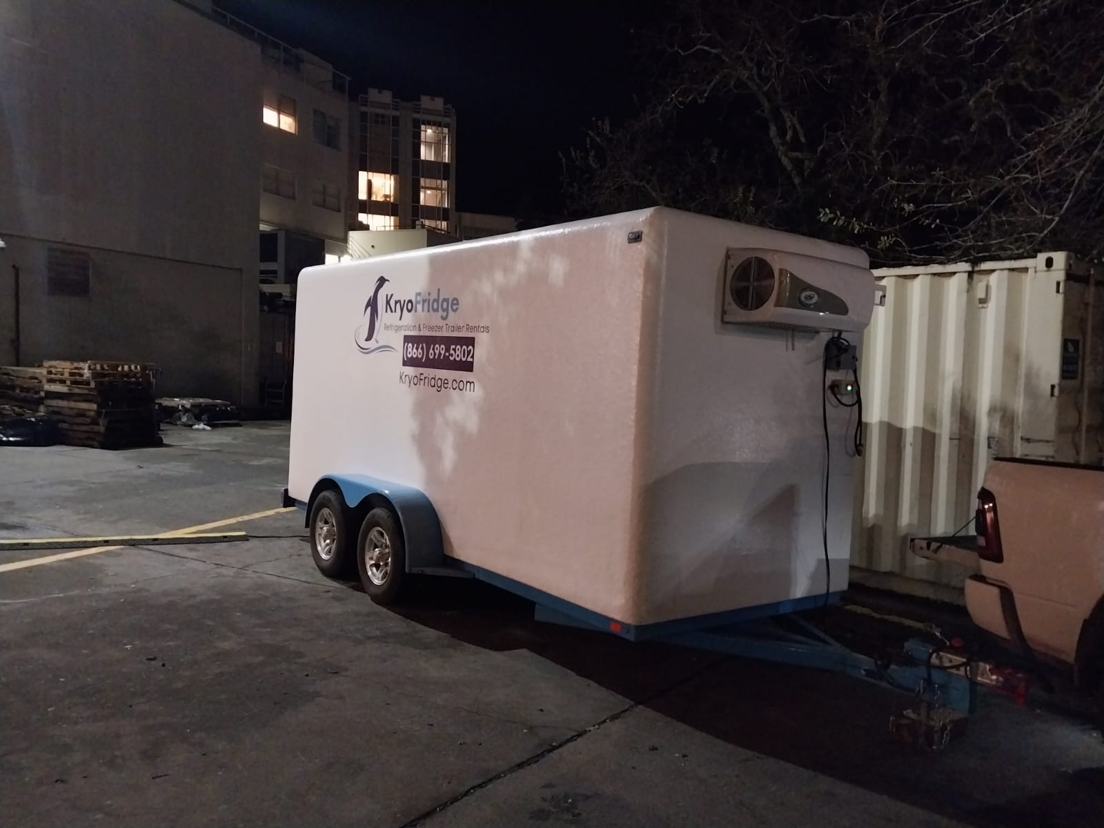 KryoFridge branded freezer trailer parked on an Escondido-area job, side view