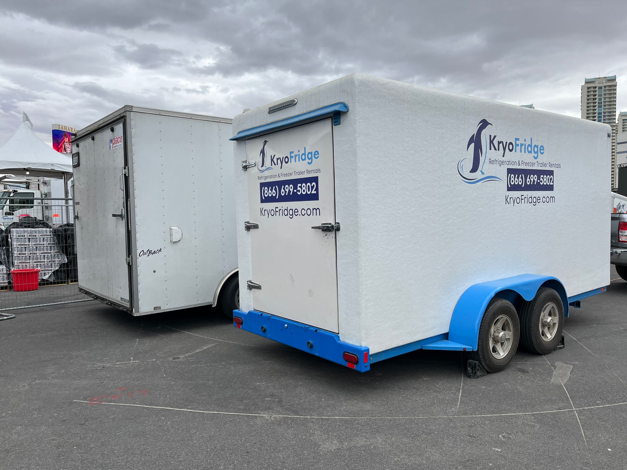 Clean white-and-blue KryoFridge freezer trailer in side profile, available to rent in Escondido