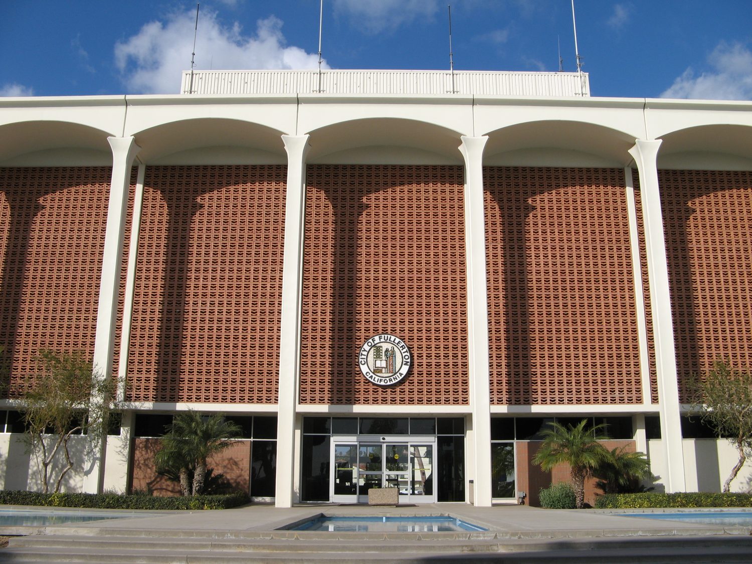 Civic building in Fullerton under bright sun, representing the hot-summer Mediterranean climate that strains refrigeration