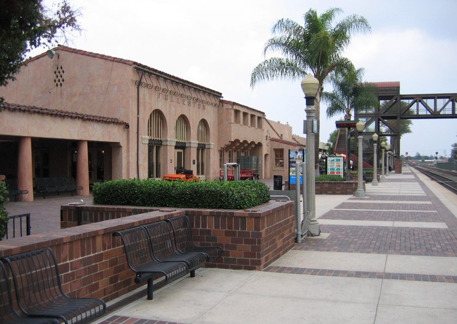 The historic Spanish-revival Fullerton train depot with FULLERTON signage and brick plaza, a recognizable downtown landmark served by KryoFridge
