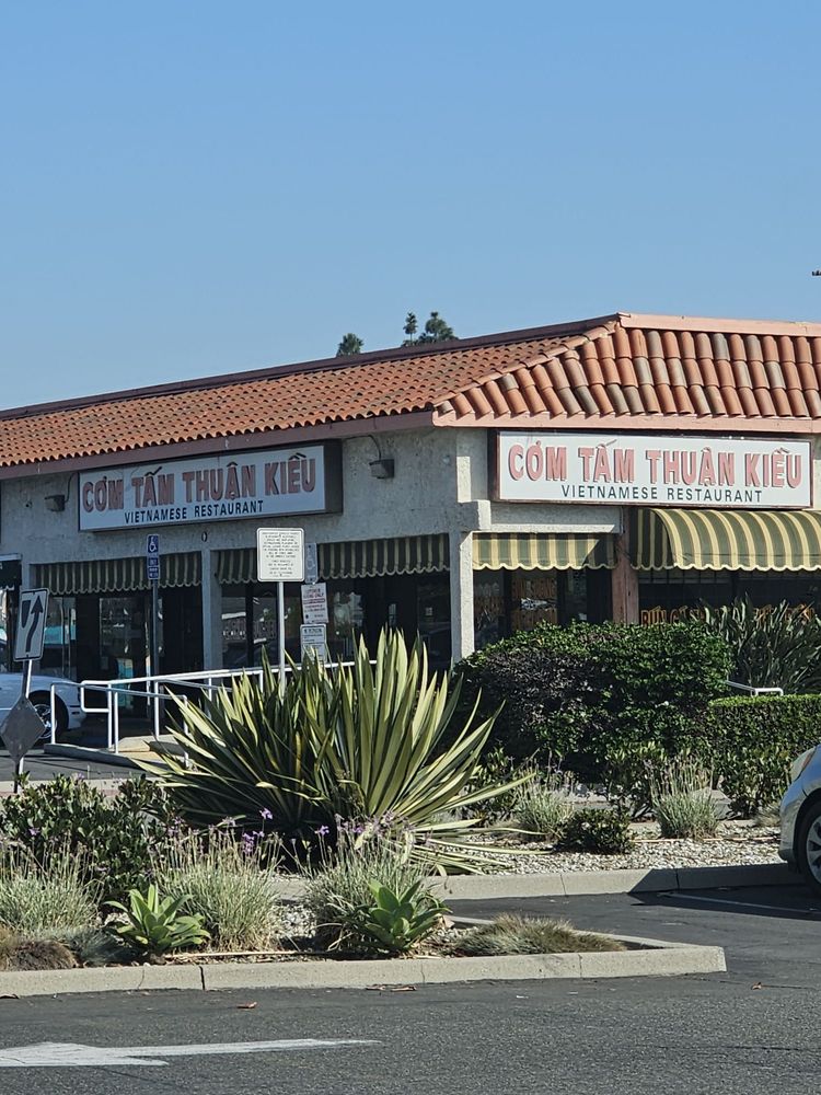 A Vietnamese restaurant storefront along a Little Saigon street in Garden Grove under clear coastal-Orange-County skies