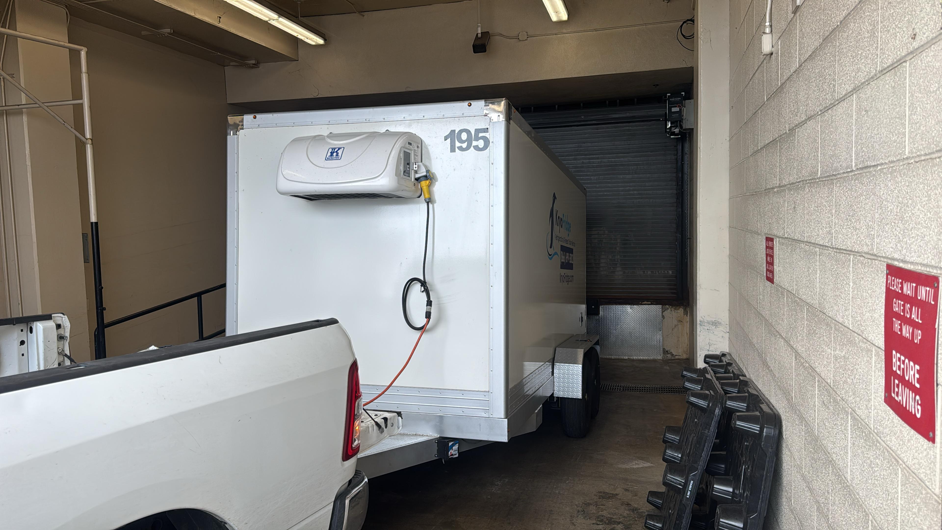 KryoFridge reefer trailer backed to a dock with its refrigeration unit running