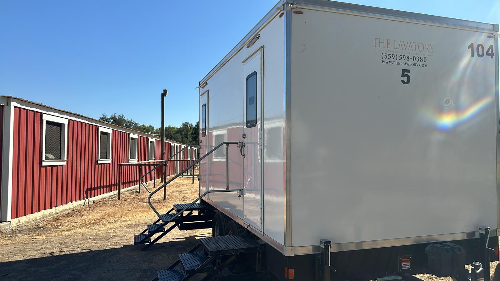 White-and-blue KryoFridge freezer trailer staged in a yard, available for rent in Garden Grove