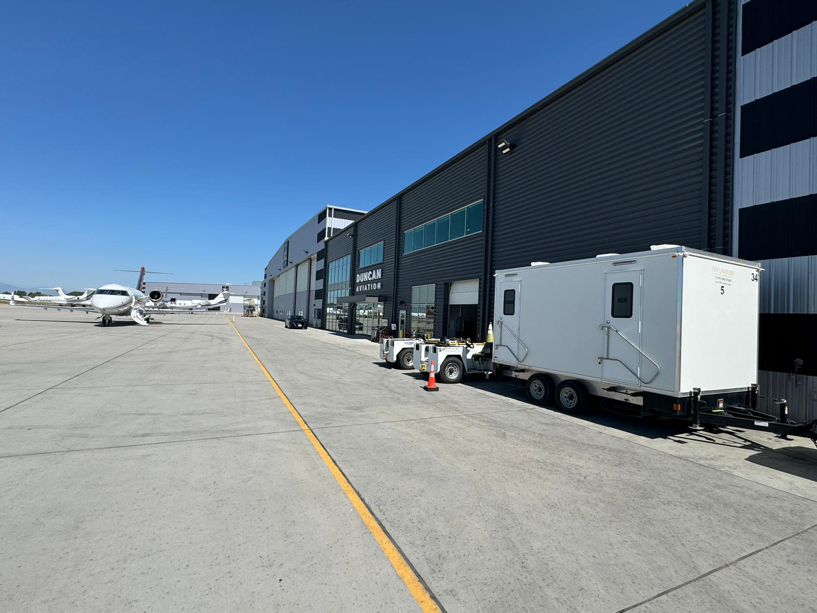 KryoFridge trailer staged beside a long distribution warehouse row in a Hayward-style 880 industrial setting