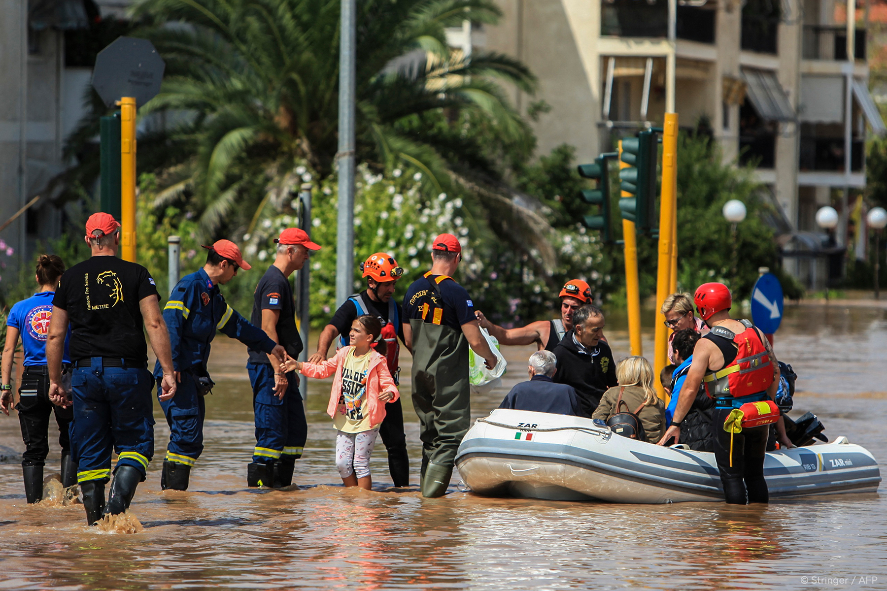 Emergency crews in floodwater, the kind of Inland Empire disaster response that needs mobile cold storage