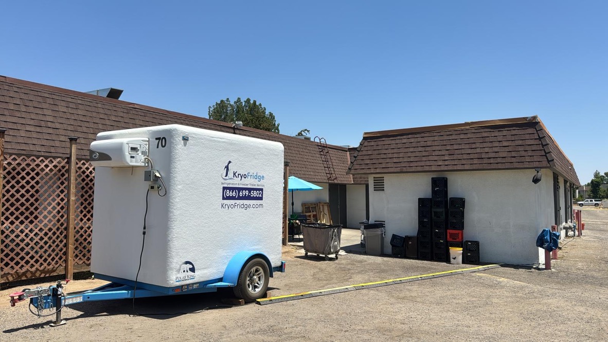 White KryoFridge walk-in freezer trailer rental parked on an Inland Empire commercial lot in Riverside County