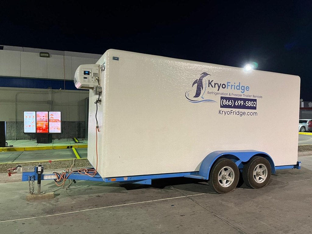 KryoFridge refrigerated trailer rental running after dark behind a San Bernardino retail kitchen