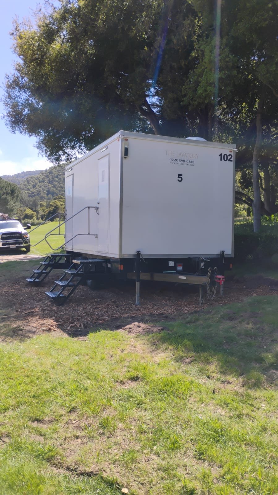 White KryoFridge cold-storage trailer positioned at a venue during daytime for temporary refrigeration