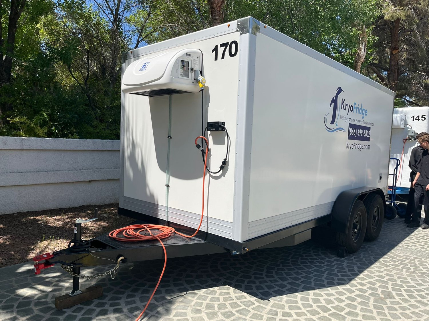 KryoFridge reefer trailer with refrigeration unit holding deep-freeze, side view on a gravel pad