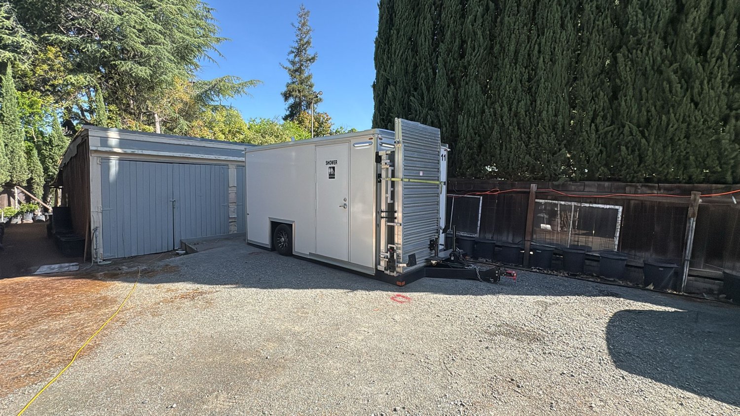 Clean white KryoFridge freezer trailer parked in a daytime lot, side profile