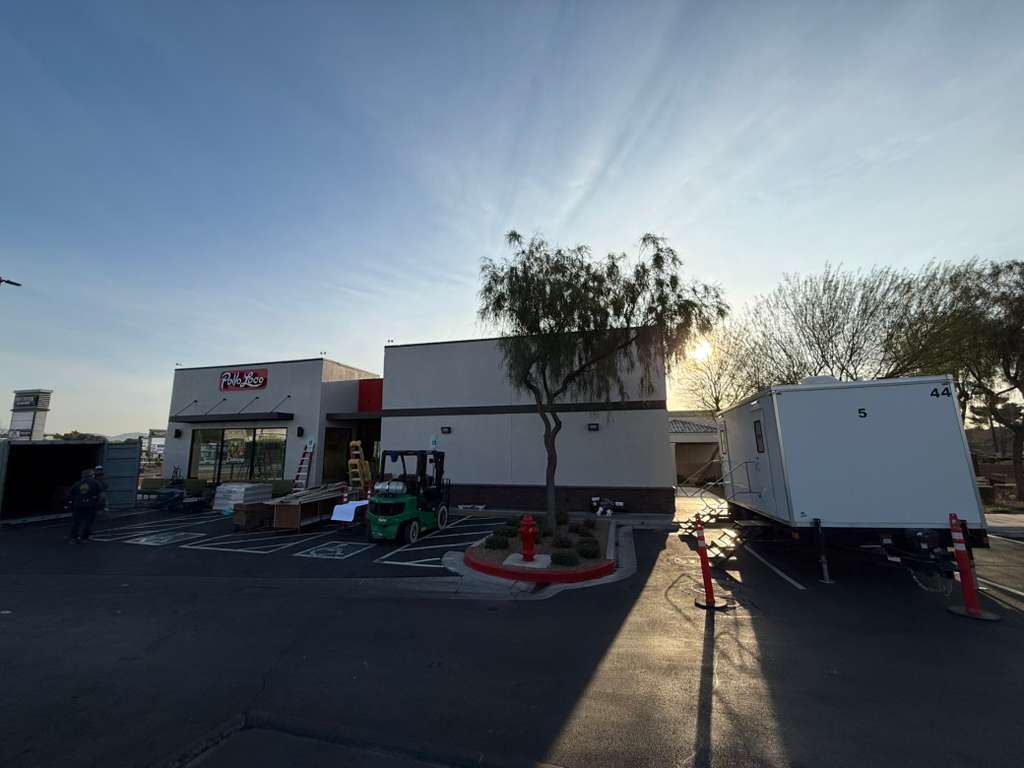 KryoFridge freezer trailer parked at a retail commercial lot at dusk providing backup cold storage for a restaurant