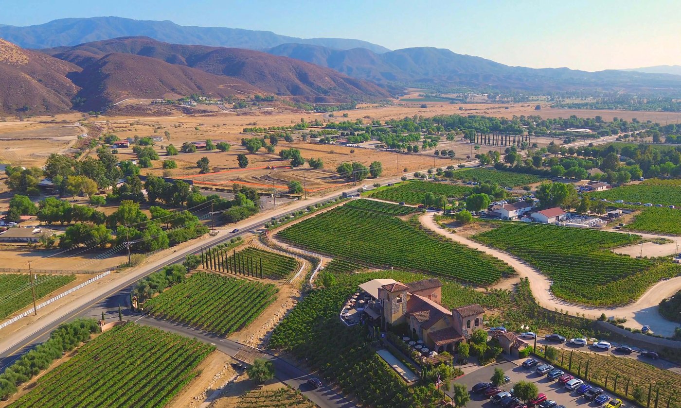 Aerial view of the Temecula Valley with vineyards, rolling hills, and the surrounding Riverside County landscape