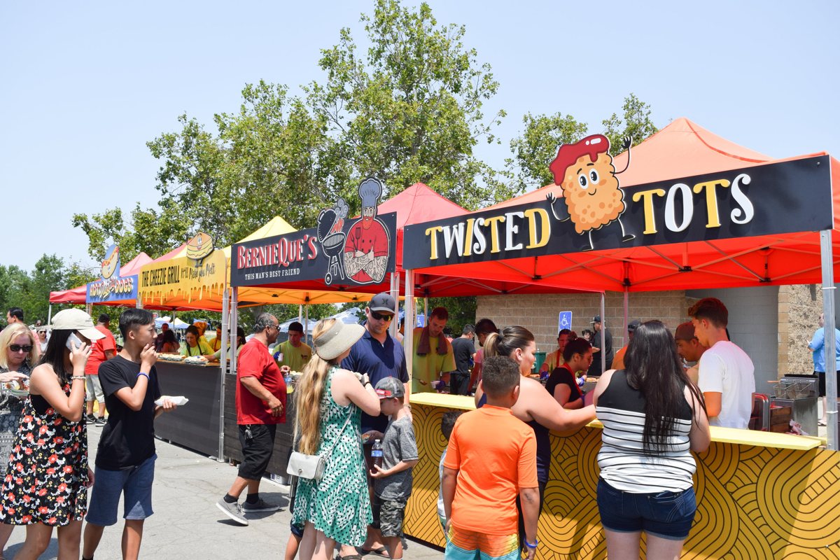 Outdoor catering buffet at an Elk Grove festival supported by a rented refrigeration trailer for cold storage