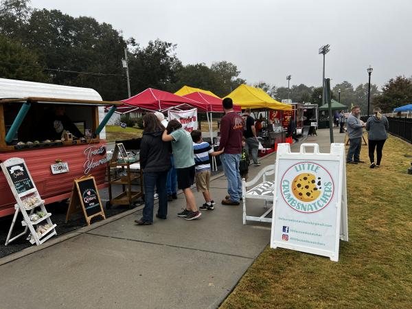 Outdoor food and beverage concessions at a Huntington Beach beach festival supported by a rented refrigeration trailer