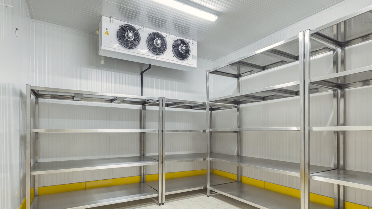 Stainless-steel walk-in cooler interior shelving inside a KryoFridge refrigerated trailer for Huntington Beach cold storage