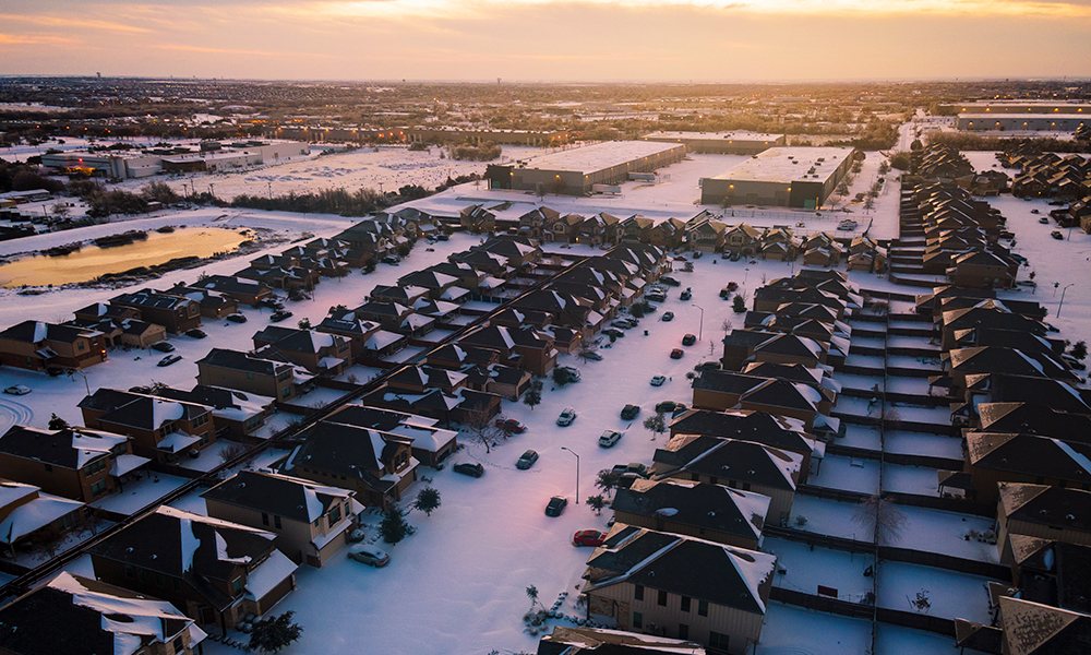 Aerial view of a snow-and-ice-covered North Texas neighborhood during the February 2021 winter storm that crippled the Texas grid