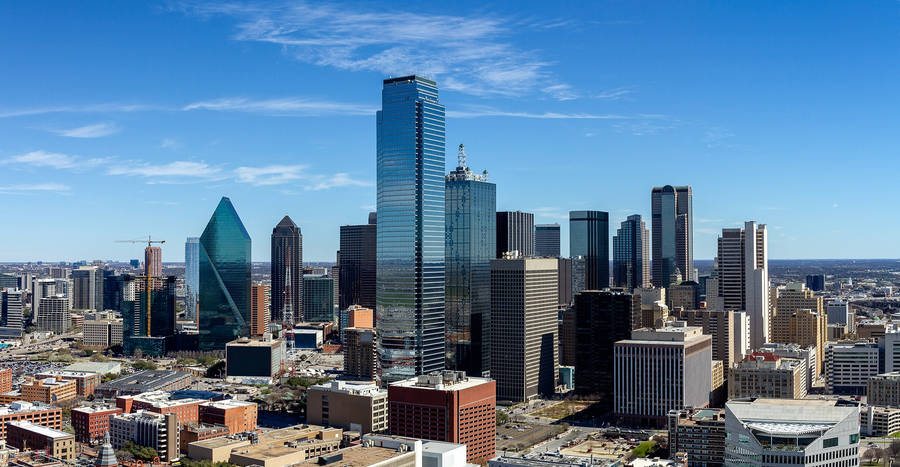 Downtown Dallas skyline against a clear Texas sky, anchor of the Dallas–Fort Worth Metroplex economy