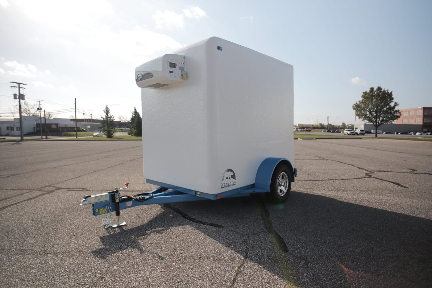KryoFridge white-and-blue freezer trailer shown in clean side profile on an open North Texas lot, staged for delivery across Dallas–Fort Worth