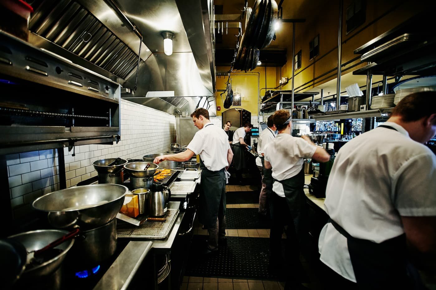 Busy commercial restaurant kitchen line mid-service in a Dallas–Fort Worth eatery