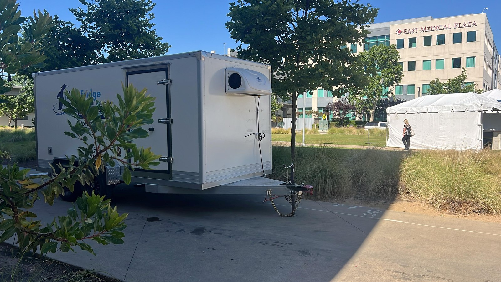 KryoFridge refrigerated trailer behind a grocery store loading dock in Round Rock with pallets of frozen goods ready to load