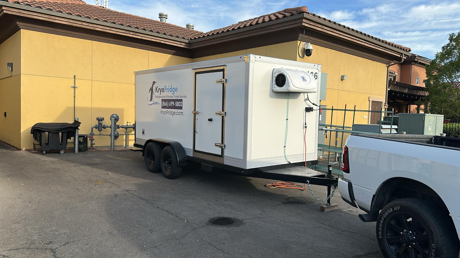Generator-powered KryoFridge freezer trailer set on a Sanger lot